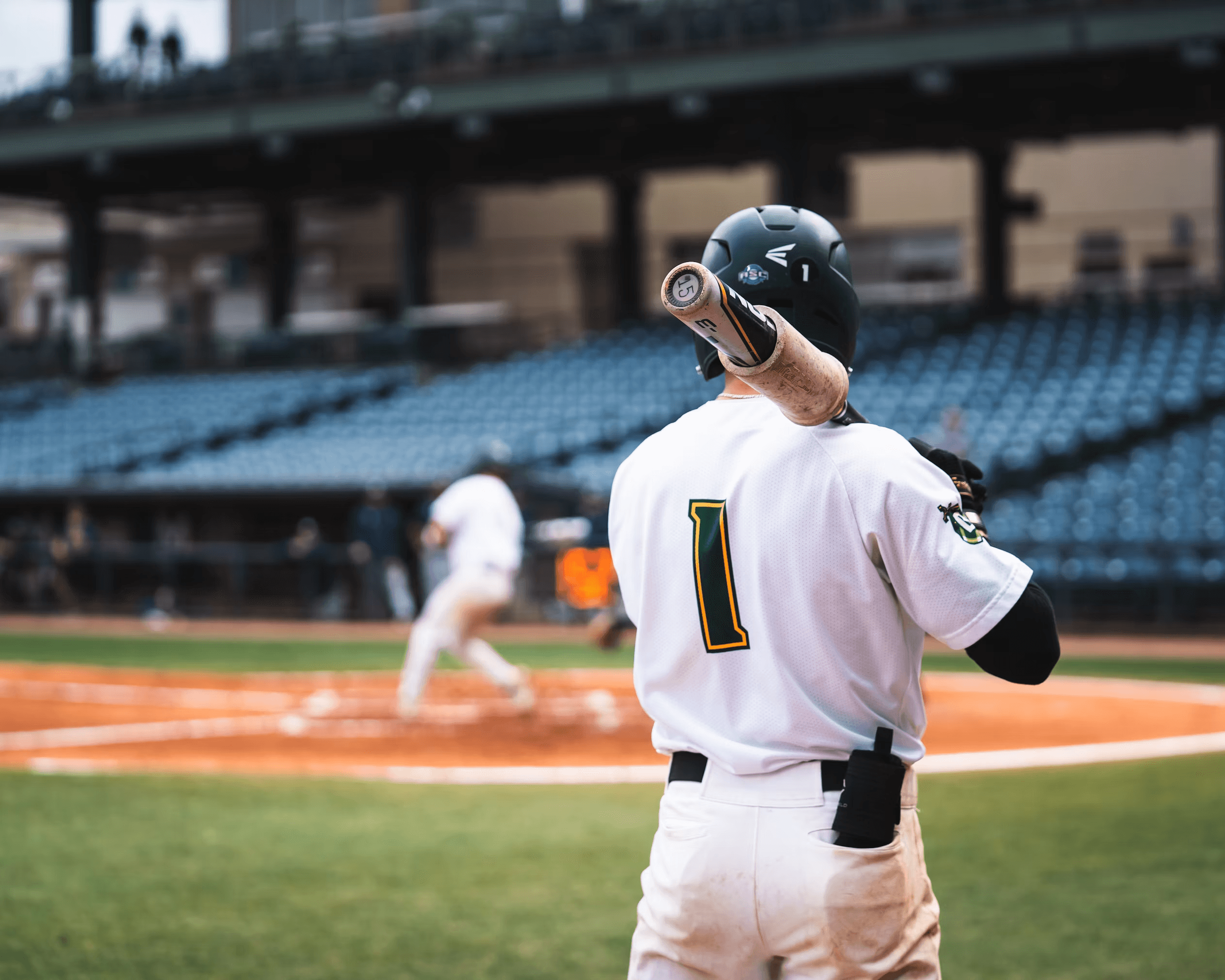 Baseball player walking onto the field